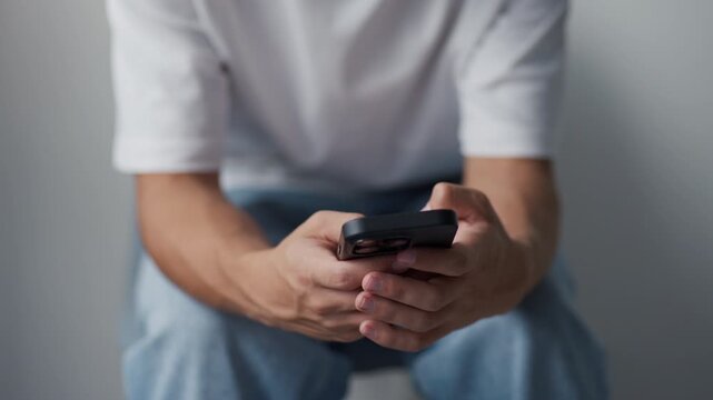 Man hands typing on a modern smartphone