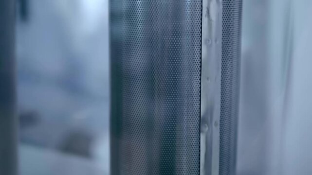 Metal filter meshes with different structures for mechanical retention of large debris in the solution. Closeup. Shot in motion