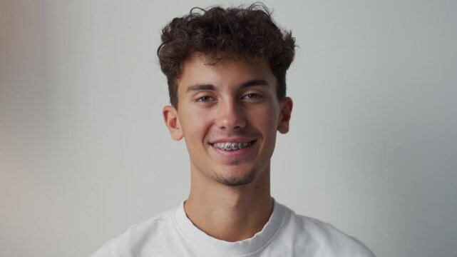 Young smiling man with braces looking at camera