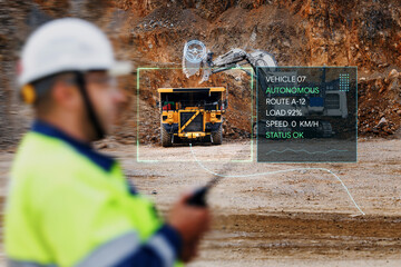 Autonomous mining dump truck at open pit quarry with operator remote control and hud telemetry overlay for industrial monitoring © Parilov