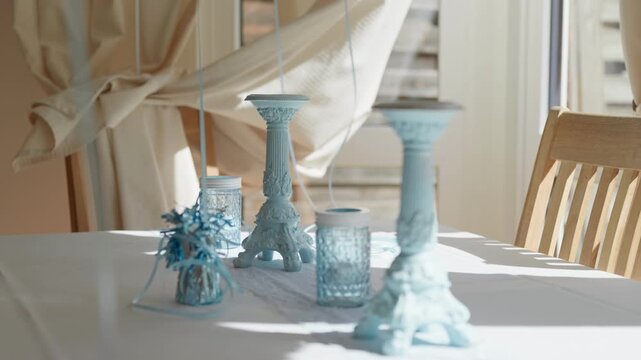 Blue candle sticks holders on the table for birthday party pulling focus transition
