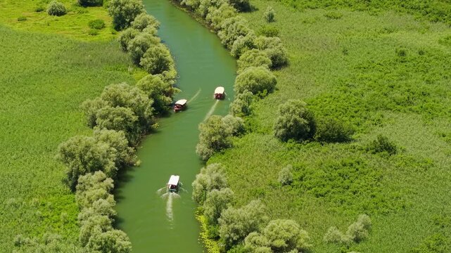 Two Boats Navigating Wetland Channel at Skadar Lake, Montenegro