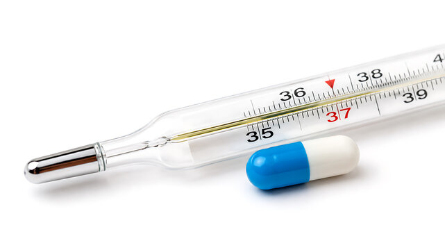 Digital thermometer and capsule on white background indicating body temperature measurement