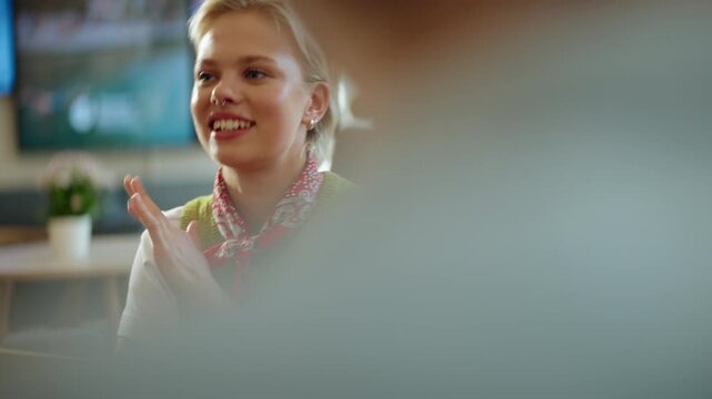 Woman joins a business meeting with listening, conversation, and collaboration in a cafe coworking space, showing teamwork, discussion, and startup culture in a flexible office.