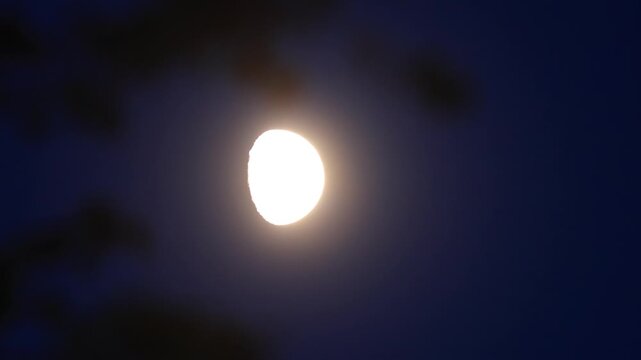 Moon on a twilight sky with landscape mountain silhouettes.
