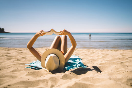 Summer reading and relaxation on sunny beach