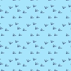 Fototapeta premium Minimalist seamless pattern with cute bird footprints on blue background