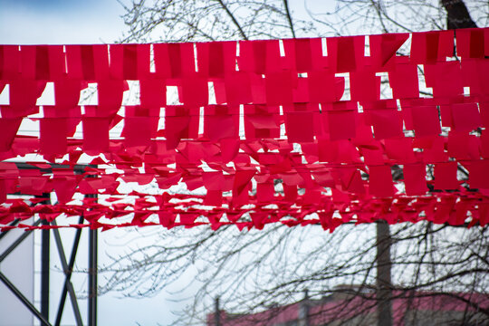 Vibrant Red Decorative Flags Hanging Outdoors Creating a Festive Urban Atmosphere