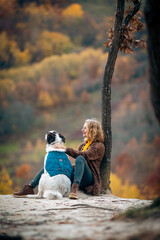 Fototapeta premium happy woman with dogs playing outdoors in autumn forest