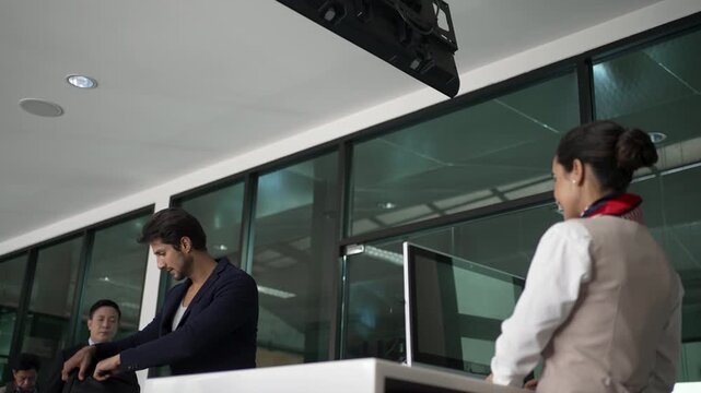 Airline Attendant Assisting Businessman at Check-In Counter