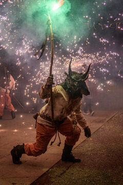 Devil figure participating correfoc fire run celebration