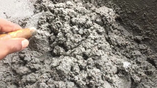 Mixing together to make a strong concrete floor, Mixing concrete concept, Slow motion