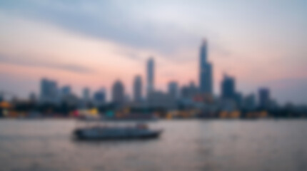 Fototapeta premium Cityscape Skyline at Dusk with Boat on Water.