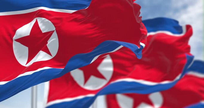 Close-up of North Korea national flags waving in the wind on a clear day