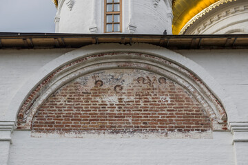 Old frescoes on the church facade © orininskaya