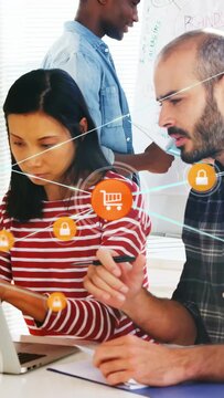 Vertical video: Analyst in office tapping laptop starting cartlock overlay team testing ecom secure
