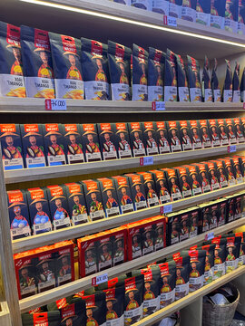 A colorful display of packaged products arranged neatly on shelves. The items feature various designs with prominent branding. The scene highlights consumer goods in a retail environment.