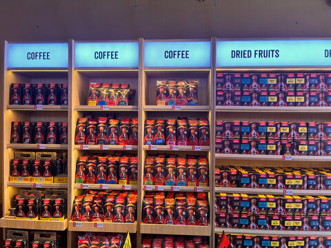 A colorful display of packaged products arranged neatly on shelves. The items feature various designs with prominent branding. 