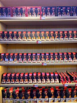 A colorful display of packaged products arranged neatly on shelves. The items feature various designs with prominent branding. The scene highlights consumer goods in a retail environment.