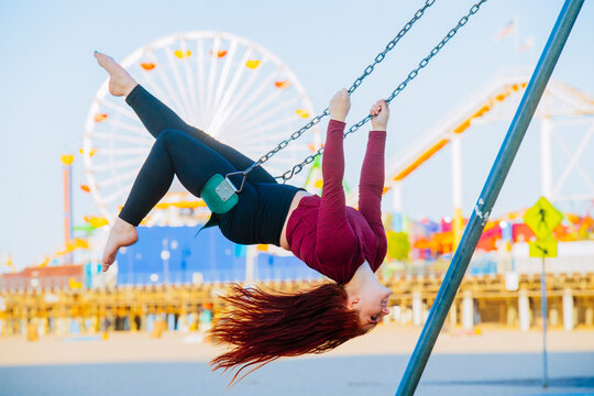 White woman swinging upside down