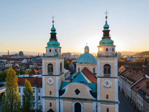 St nicholas' cathedral towering over ljubljana cityscape at sunset