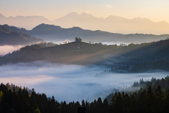 St Thomas's Church on a misty hill at Sunrise in skofja loka