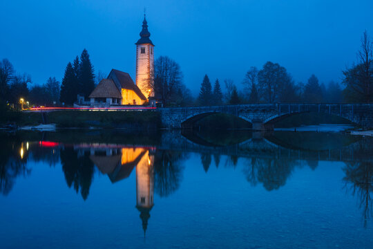 Church of st john the baptist with river reflection in bohinj Slovenia
