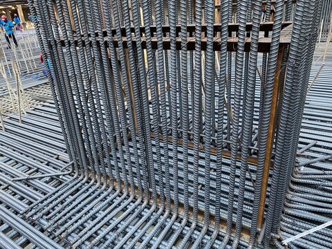 Steel reinforcement and temporary supports at an urban construction site in Silom, Bangkok, Thailand.