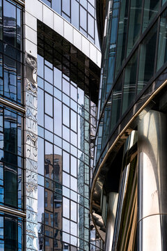 Glass facade and curved architectural detail in Warsaw, Poland, showing modern office buildings with reflective windows and urban contemporary design