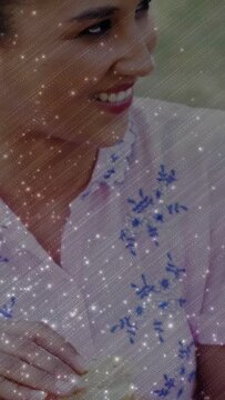 Vertical video: Woman touching snack, peeling it and turning head, sparkly overlay showing food ad