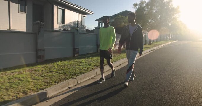 Lifestyle videos outdoor of people doing activities, running together on suburban street, two men en