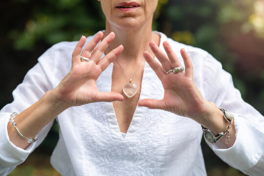 Coherence: mindfulness coach holding hands open outdoors, expressing emotional balance, inner alignment, focused awareness and spiritual harmony.