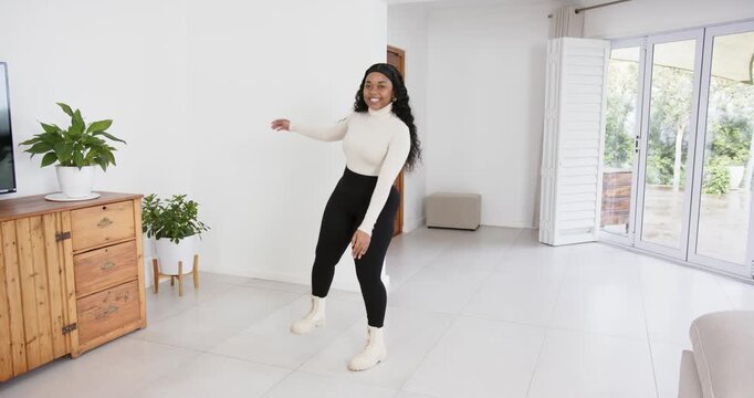 High speed photography for dynamic scenes, smiling woman dancing in living room, enjoying leisure ti