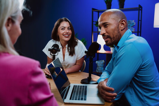 Group of three hosts is capturing a live audio broadcast
