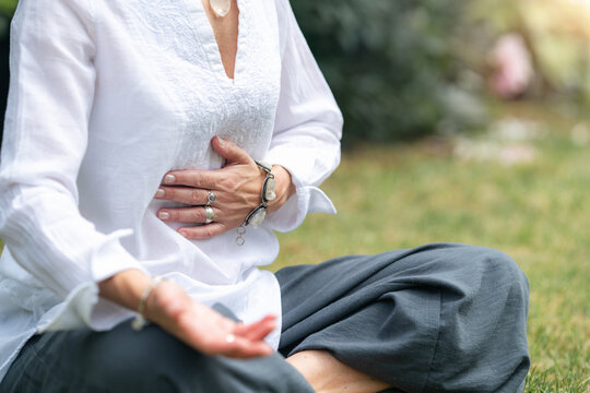 Mindfulness practice featuring a solar plexus and abdominal centering posture that encourages emotional resilience, grounding, inner confidence, mindful awareness, and holistic wellbeing  