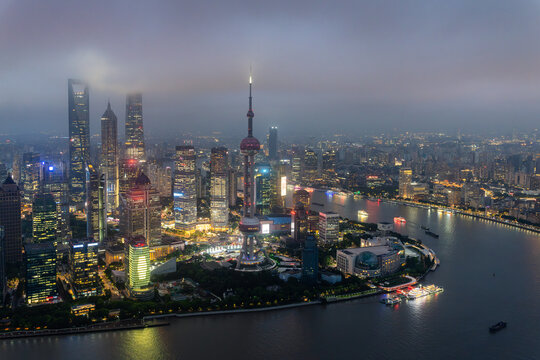 Aerial night view of the illuminated Oriental Pearl Tower and Shanghai Lujiazui financial skyline