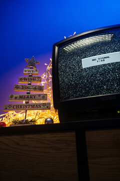 Vintage CRT television, no signal static, glowing lights and festive holiday decorations