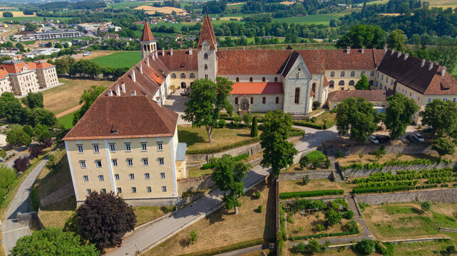 Aerial view of historic St Paul Abbey Benedictine monastery and church in Sankt Paul im Lavanttal, Carinthia. Ancient architectural complex stands against green hills in summer.