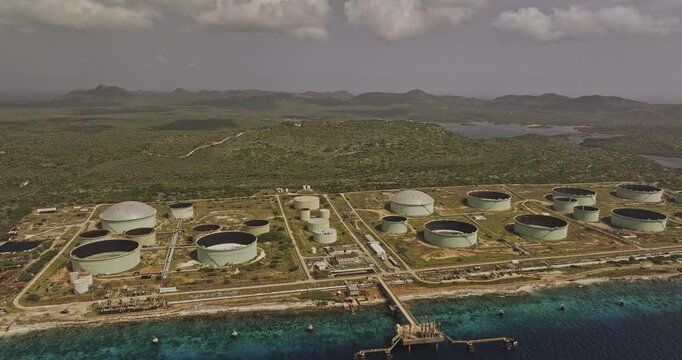 Bonaire Caribbean Netherlands Aerial v71 high rising flyover shoreline, capturing BOPEC terminal's oil storage tanks and Washington Slagbaai National Park - Shot with 5k Camera - Feb 3rd 2024