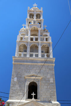 The ornate white bell tower of the Church of St. John in the harbor town of Yialos on the Greek island of Symi.