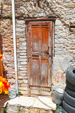 Old, worn wooden door on a house, Symi Island, Greece.