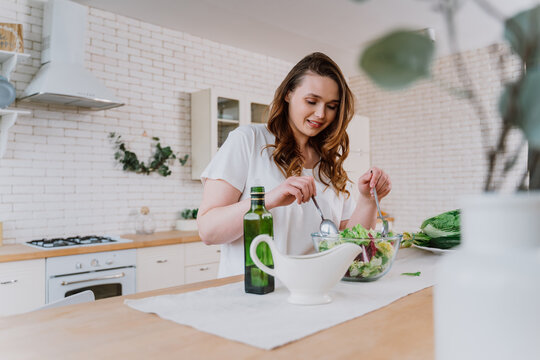 Woman preparing a salad in the kitchen