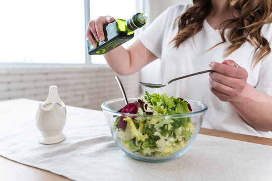 Woman preparing a salad in the kitchen