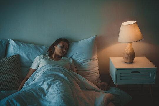 Woman sleeping in her bed
