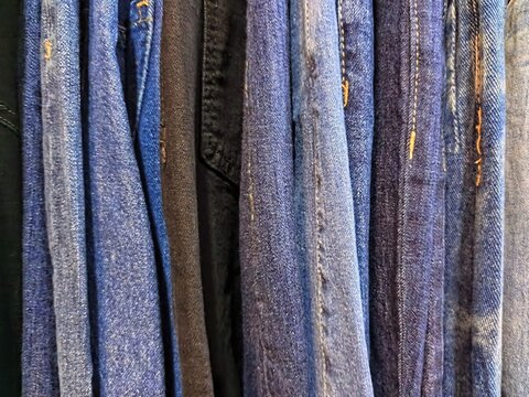 Close up texture of blue denim jeans fabric with seams