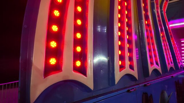 Amusement park attraction with colorful flashing LED lights illuminating the night
