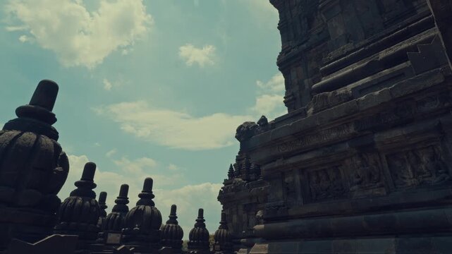 Side View of Intricate Stone Carvings and Stupas at Temple