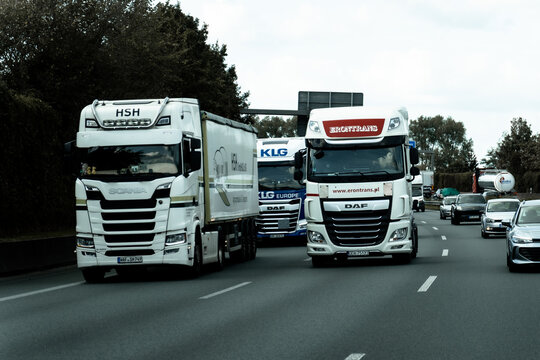 DUSSELDORF AREA, GERMANY - SEPTEMBER 21, 2026: Freight trucks from European logistics companies travel on a busy German motorway