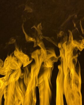 View of flickering golden flames rising against a dark background in a spa setting in Banya, Blagoevgrad Province, Bulgaria.