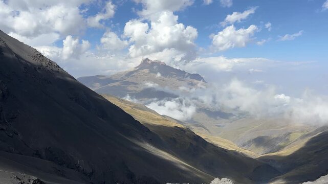 4K Timelapse of Clouds Rolling Over Rugged Mountain Valley